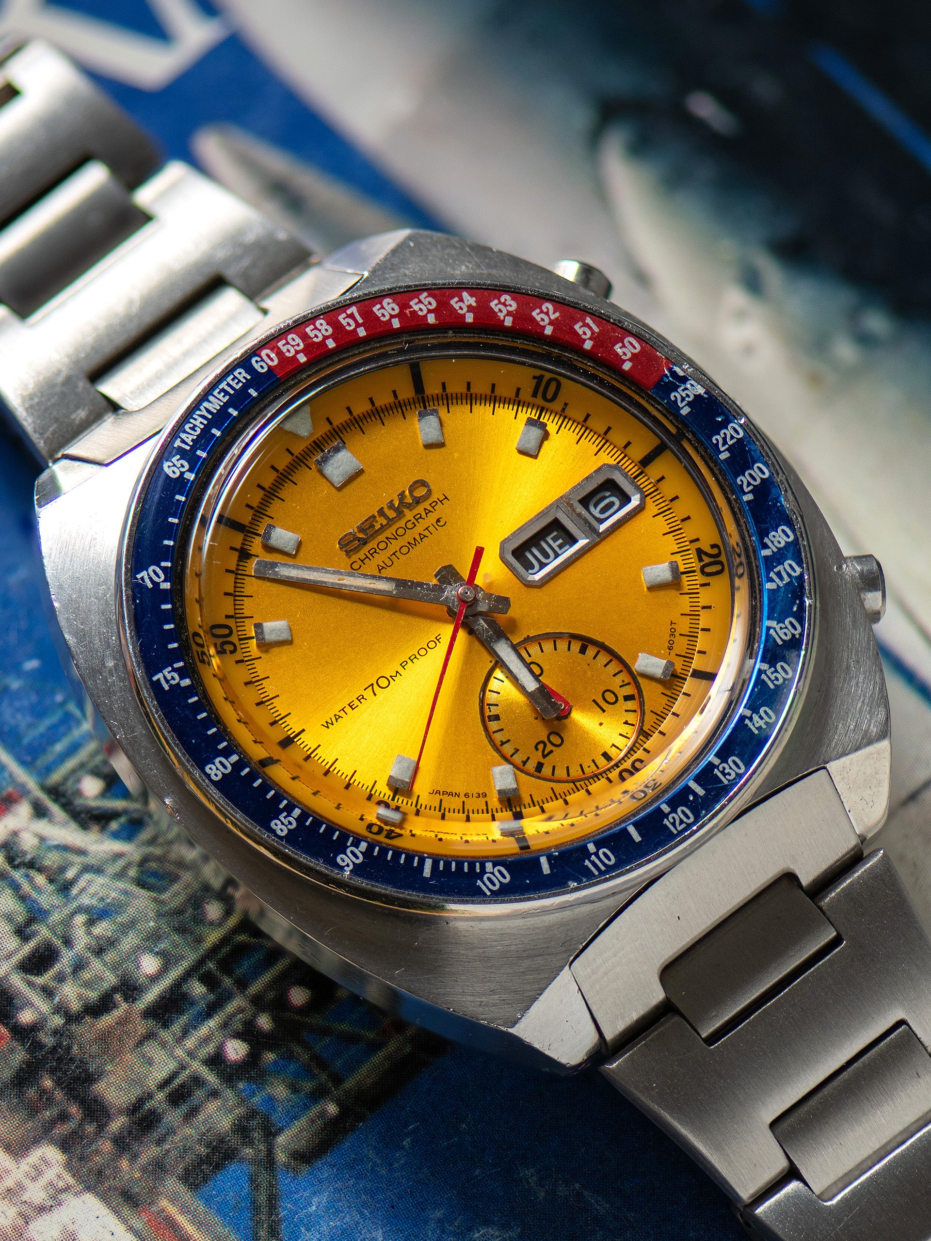 Seiko 6139-6000, Gold Dial, Notch Case. Documented specimen has an aftermarket bracelet. Photo: Craft + Tailored. · Photo: Craft + Tailored · © Craft + Tailored, used with permission · Source: https://www.craftandtailored.com/collections/seiko/products/1969-seiko-automatic-chronograph-pogue-ref-6139-6000-notch-case