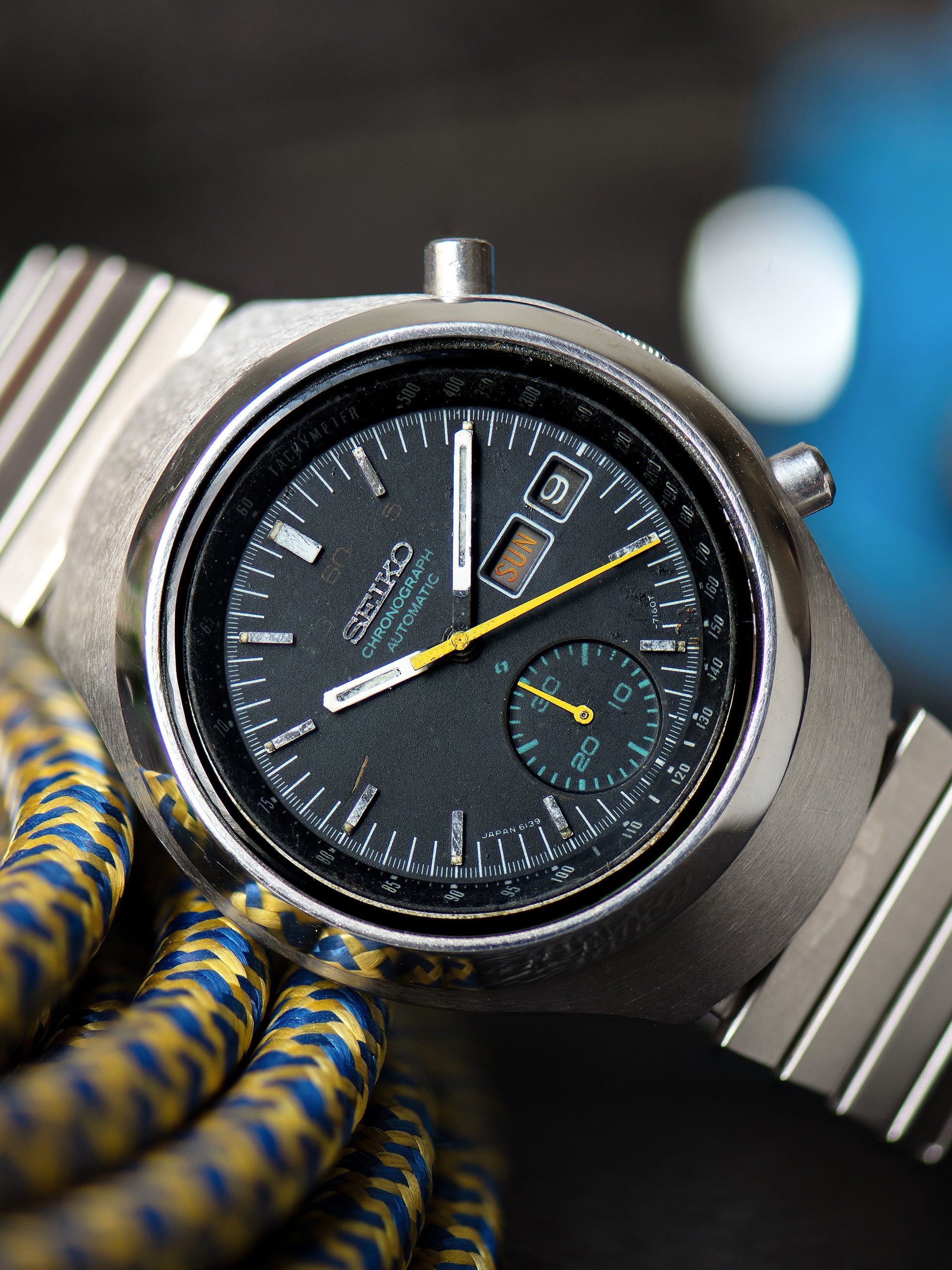 Seiko 6139-7100, Black Dial, Yellow Chronograph Hands. Documented specimen has restored hand lume. Photo: Craft + Tailored. · Photo: Craft + Tailored · © Craft + Tailored, used with permission · Source: https://www.craftandtailored.com/products/1977-seiko-automatic-chronograph-ref-6139-7100